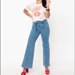 New with tags, light indigo belted flare jeans from Unique Vintage